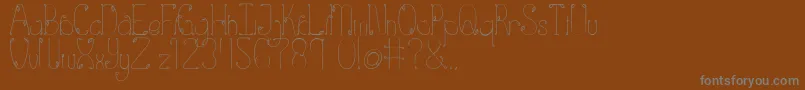 Eden-fontti – harmaat kirjasimet ruskealla taustalla