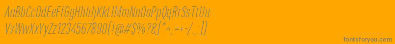 MarianinaCnFyLightItalic-fontti – harmaat kirjasimet oranssilla taustalla