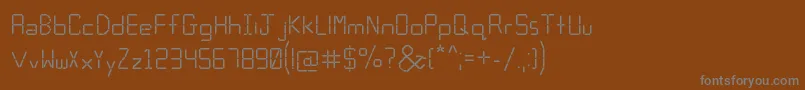 Calculator-fontti – harmaat kirjasimet ruskealla taustalla