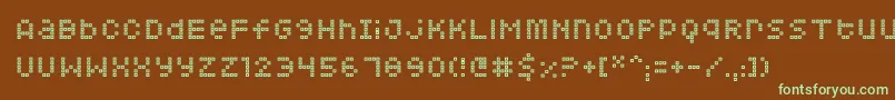 フォントSquarodynamic 07 – 緑色の文字が茶色の背景にあります。