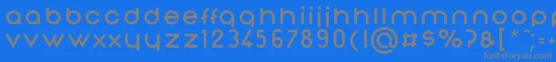 NonchalanceBold-fontti – harmaat kirjasimet sinisellä taustalla