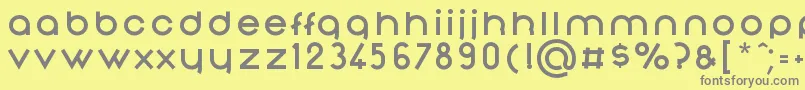 NonchalanceBold-fontti – harmaat kirjasimet keltaisella taustalla