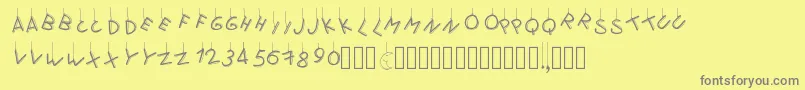 Pwflymetothemoon-fontti – harmaat kirjasimet keltaisella taustalla