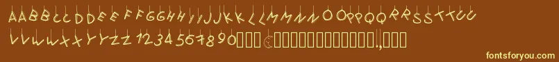 Pwflymetothemoon-fontti – keltaiset fontit ruskealla taustalla