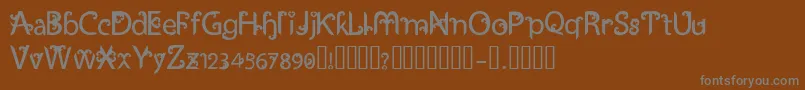 UkiranJawi-fontti – harmaat kirjasimet ruskealla taustalla