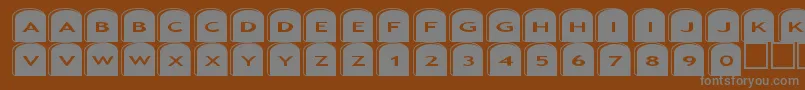 Asgravestones2-fontti – harmaat kirjasimet ruskealla taustalla