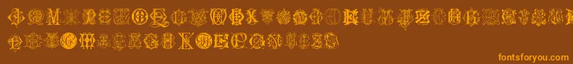 フォントIntellectaMonogramsRandomSamplesSix – オレンジ色の文字が茶色の背景にあります。