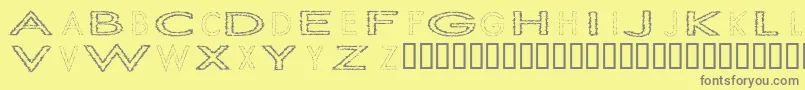 SlurCrumb-Schriftart – Graue Schriften auf gelbem Hintergrund