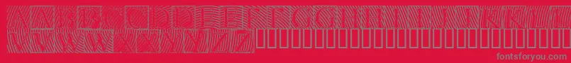 Lowengravedcapshollow-Schriftart – Graue Schriften auf rotem Hintergrund