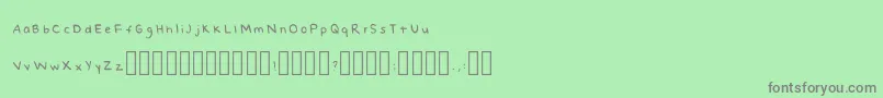 NaomishandRegular-fontti – harmaat kirjasimet vihreällä taustalla