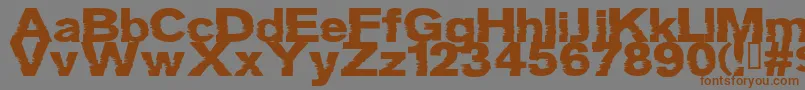 フォントGrotb – 茶色の文字が灰色の背景にあります。