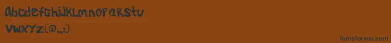 Czcionka Aliend – czarne czcionki na brązowym tle