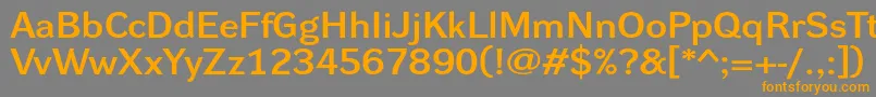 フォントDynagroteskdxe – オレンジの文字は灰色の背景にあります。