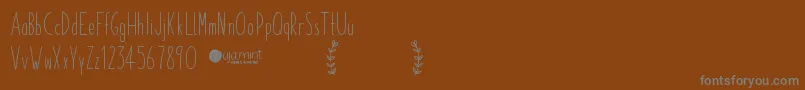 Czcionka PaperdaisyDemo – szare czcionki na brązowym tle