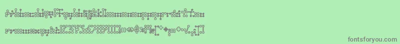 Wednesda-fontti – harmaat kirjasimet vihreällä taustalla