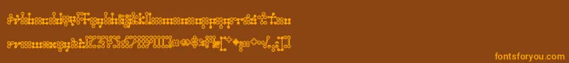 フォントWednesda – オレンジ色の文字が茶色の背景にあります。