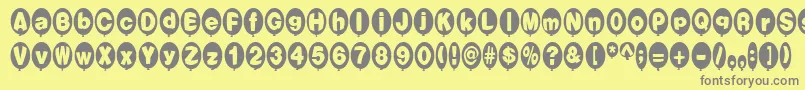 BalloonsNormal-fontti – harmaat kirjasimet keltaisella taustalla