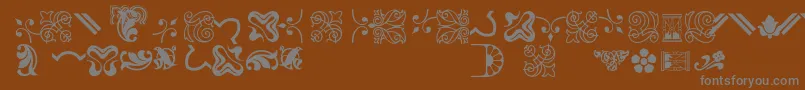 フォントBordersornament3 – 茶色の背景に灰色の文字