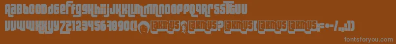 Lakmus-fontti – harmaat kirjasimet ruskealla taustalla