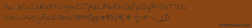 フォントNarinx – 黒い文字が茶色の背景にあります