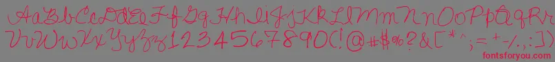 フォントLisasfirstclass – 赤い文字の灰色の背景