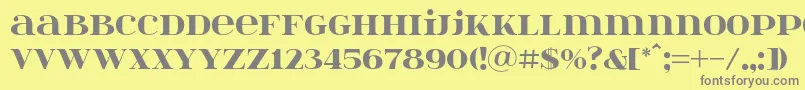 フォントItsadzoke046 – 黄色の背景に灰色の文字