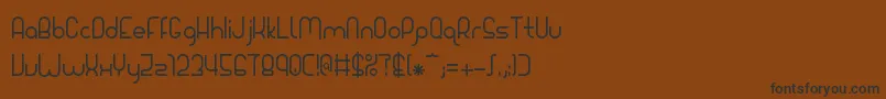 フォントGiada – 黒い文字が茶色の背景にあります