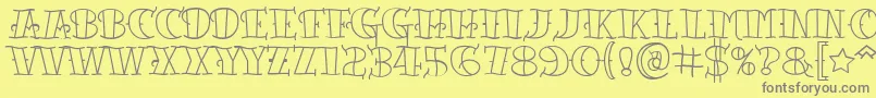 フォントTattooletteringopen – 黄色の背景に灰色の文字