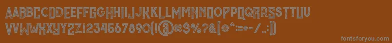 MurrayInlineGrunge-fontti – harmaat kirjasimet ruskealla taustalla