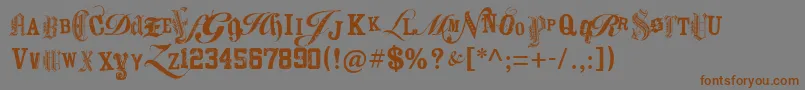 フォントKeetanoAtlMygangsta – 茶色の文字が灰色の背景にあります。