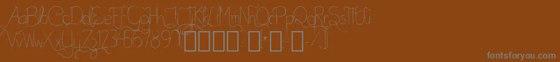 BellaKABetterPlace-fontti – harmaat kirjasimet ruskealla taustalla