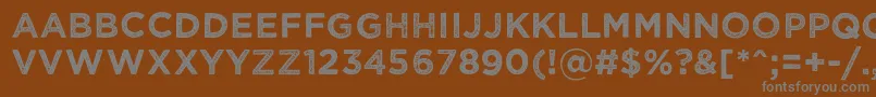 Wickedgrit-fontti – harmaat kirjasimet ruskealla taustalla