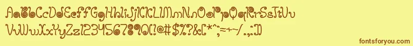 フォントLicoriceStringsBrk – 茶色の文字が黄色の背景にあります。