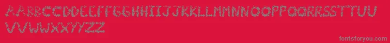 Popcornfont-fontti – harmaat kirjasimet punaisella taustalla