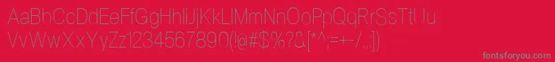 NeogramUltralightcnd-fontti – harmaat kirjasimet punaisella taustalla