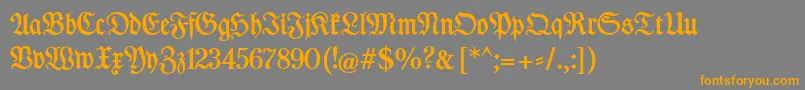 DesMalersFraktur-Schriftart – Orangefarbene Schriften auf grauem Hintergrund