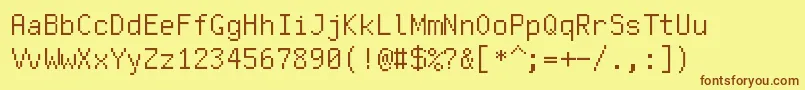 フォントFreepixel – 茶色の文字が黄色の背景にあります。