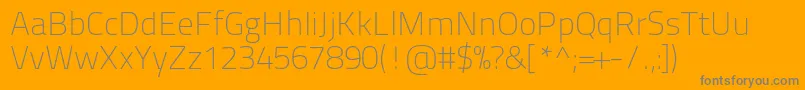 Titilliumtext22l1wt-fontti – harmaat kirjasimet oranssilla taustalla