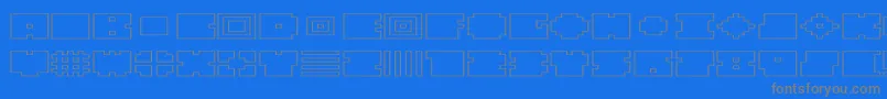 QubeHollowWide-fontti – harmaat kirjasimet sinisellä taustalla