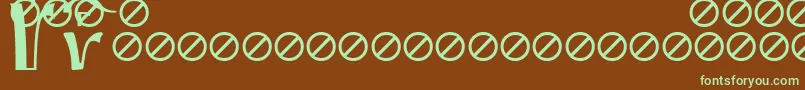 フォントIrmologionEtceteratitles – 緑色の文字が茶色の背景にあります。