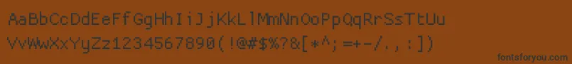 Fonte Proggycleansz – fontes pretas em um fundo marrom