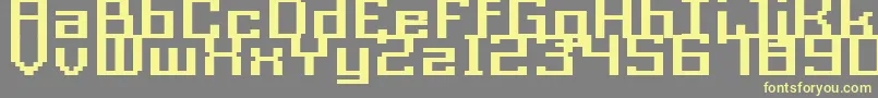 フォントAcme9RegularBoldXtnd – 黄色のフォント、灰色の背景