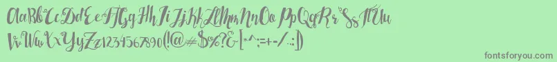 フォントLasermetal – 緑の背景に灰色の文字