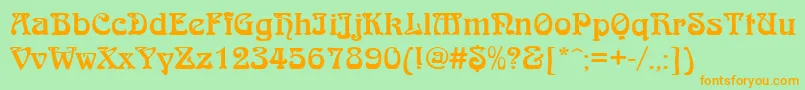 フォントQtarniebRegular – オレンジの文字が緑の背景にあります。