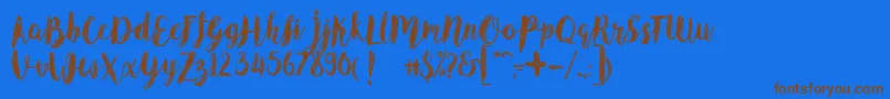 フォントAngelineVintageDemo – 茶色の文字が青い背景にあります。