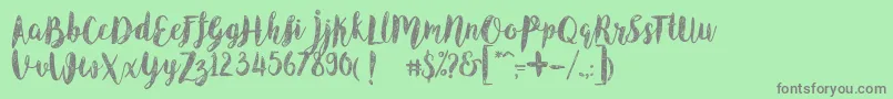 AngelineVintageDemo-fontti – harmaat kirjasimet vihreällä taustalla
