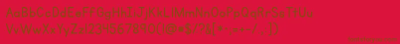 Police Kgprimarypenmanshipalt – polices brunes sur fond rouge
