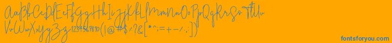 StylishcharmFree-Schriftart – Blaue Schriften auf orangefarbenem Hintergrund