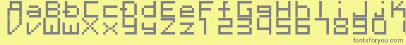 Megaten20xx-fontti – harmaat kirjasimet keltaisella taustalla