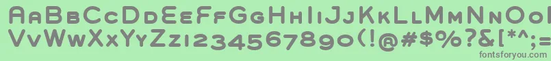 GroverCapsBold-fontti – harmaat kirjasimet vihreällä taustalla